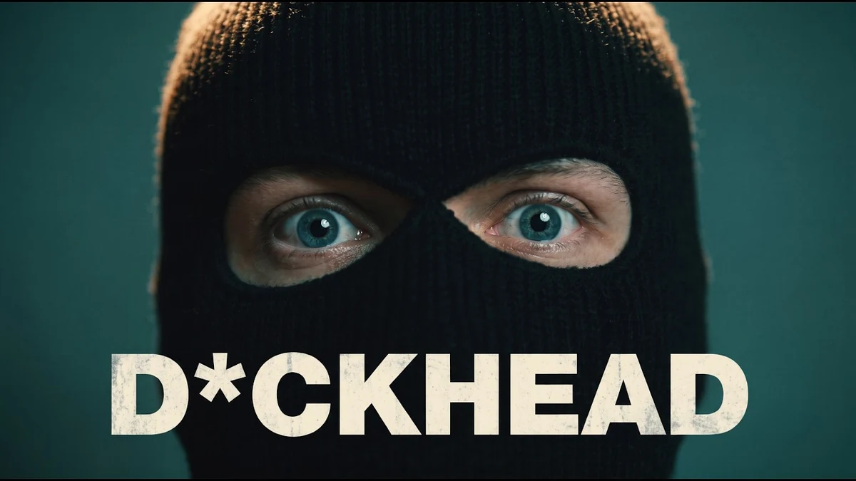 Masked bank robber staring through a black balaclava in Timothy Solinger’s AI short film D*CKHEAD.