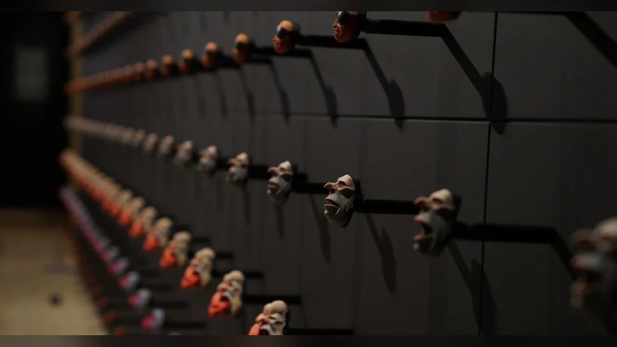 Rows of genuine 3D-printed stop-motion replacement faces with the factual callout 106,000 faces.