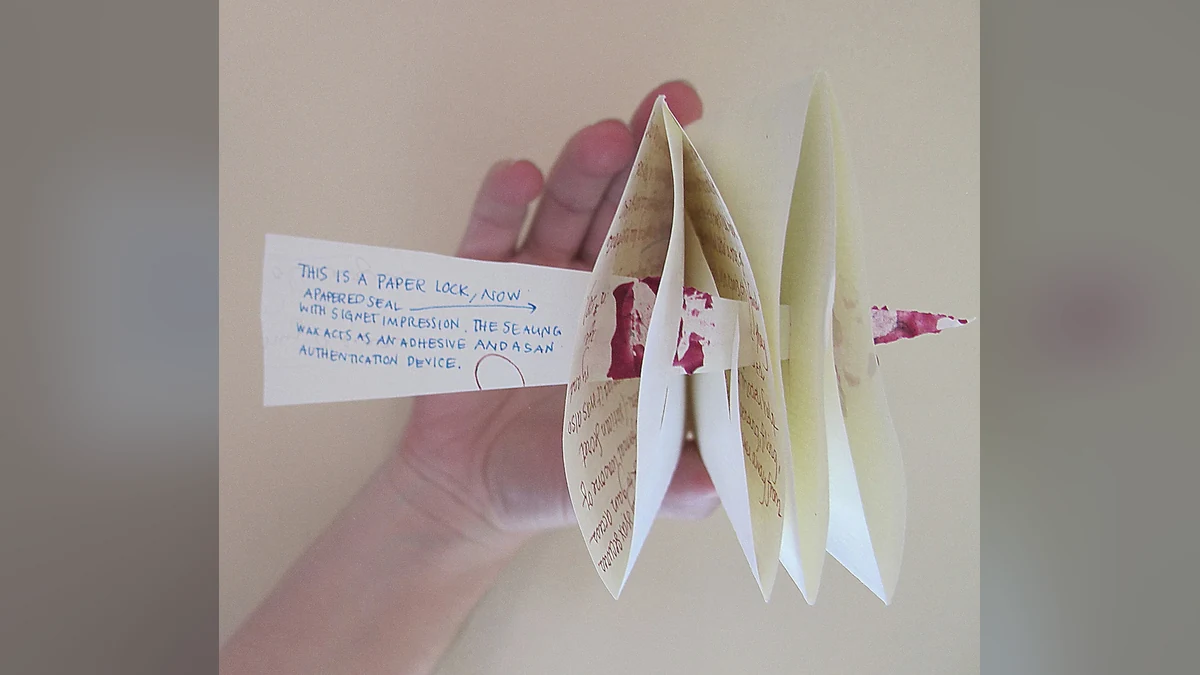 A folded letterlocked packet beside its unfolded paper pattern, showing how one sheet becomes its own secure envelope.